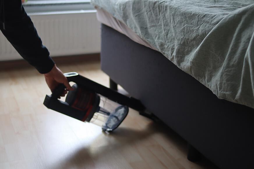 Shark Anti Hair Wrap Flexoloxy is seen cleaning under furniture.